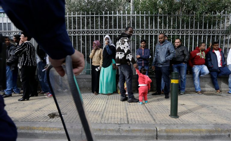 Immigrants from various countries queue outside Greece's Central Asylum Service in Athens on Wednesday, Oct. 8, 2014. The United Nations refugee agency is calling on the European Union to overhaul its policy toward Syrian refugees, warning the number of fatal accidents at sea could rise further as winter approaches. Greek authorities says they expect a three-fold increase in the number of would-be immigrants and asylum seekers apprehended this year, compared with 2013, with most now coming from Syria. (AP Photo/Thanassis Stavrakis)