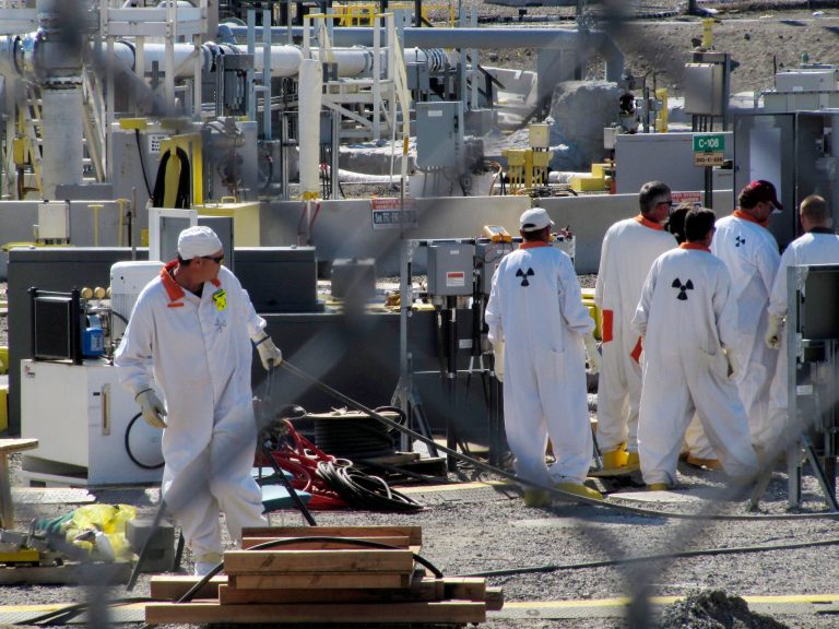 Workers at the Hanford nuclear reservation work around a tank farm where highly radioactive waste is stored underground. Six underground radioactive waste tanks at the nation's most contaminated nuclear site are leaking, Gov. Jay Inslee said on Feb. 22, 2013. (AP Photo/Shannon Dininny, File)