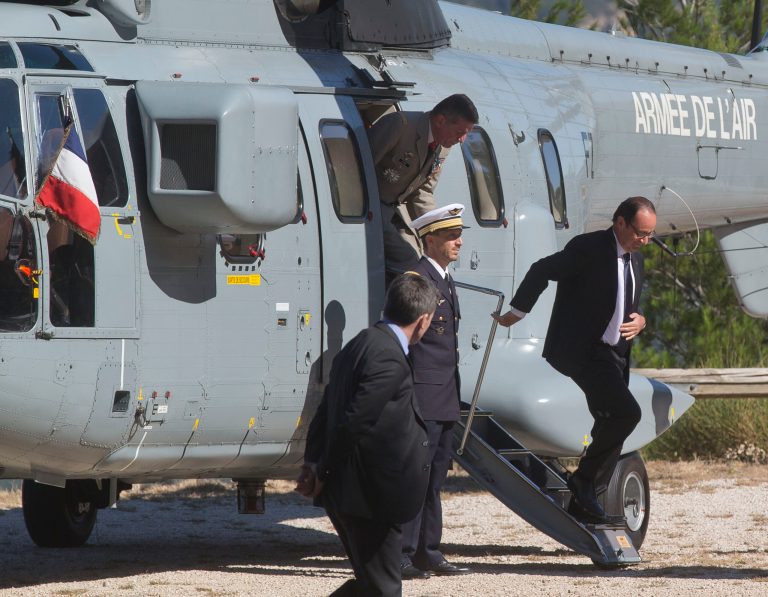French President Francois Hollande, gets out from a Super Puma helicopter as he arrives with French officials to a ceremony to pay tribute to the French resistance during World War II, at the Mont Faron memorial in Toulon, southern France, Friday, Aug. 15, 2014. France celebrates the 70th anniversary of the Allied invasion of its southern coast, highlighting the participation of African troops to the operation, launched ten weeks after D-Day, that hastened the German defeat and the end of the World War II. (AP Photo/Michel Euler, Pool)