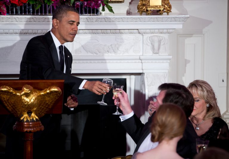 President Barack Obama toasts after delivering remarks during a dinner for the National Governors Association in the State Dining room of the White House on Sunday, Feb. 23, 2014, in Washington. (AP Photo/ Evan Vucci)