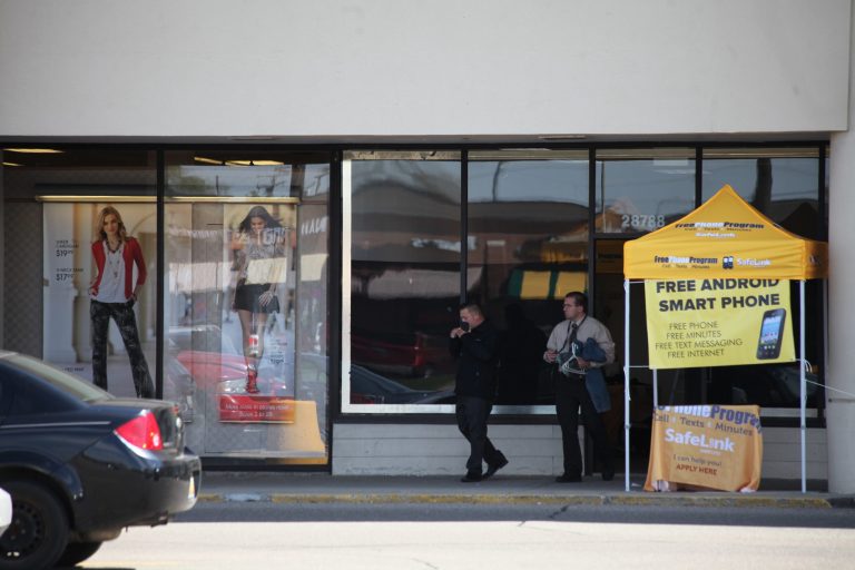 A sidewalk tent offers deals on cell phones outside the now-empty office space that served as a 2016 campaign office for Hillary Clinton in a Roseville, Mich., strip mall on May 3. (Frank Craig for Washington Examiner)