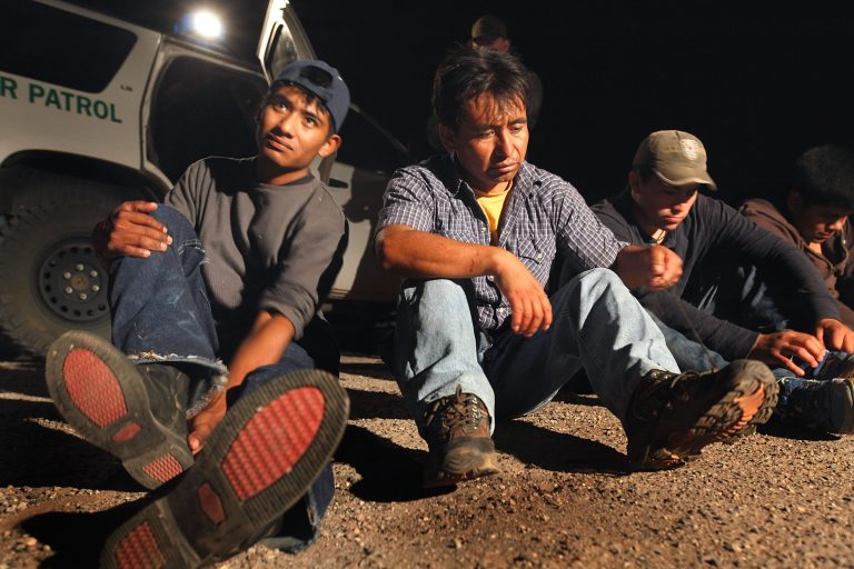 Undocumented immigrants apprehended in the desert near the Mexican border are processed before being transported to a detention center June 1, 2010 near Sasabe, Ariz. (Photo by Scott Olson/Getty images)
