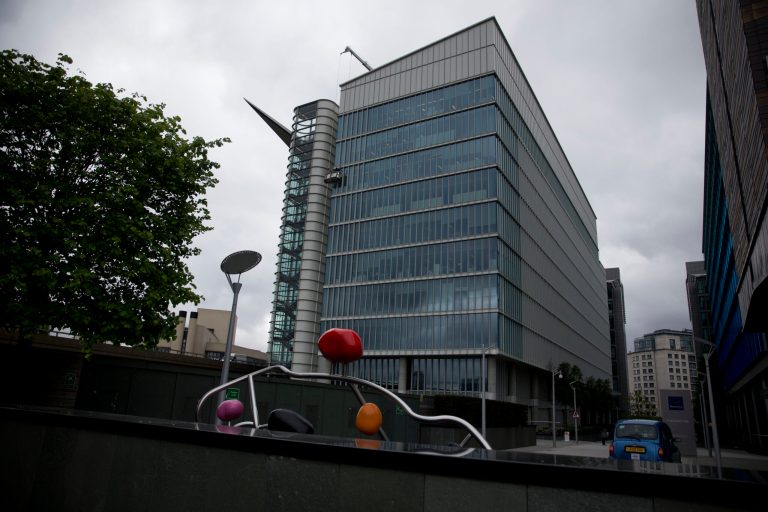 FILE- In this Friday, May 2, 2014 file photo, an exterior view of the Two Kingdom Street building which houses the headquarters of AstraZeneca, in the Paddington area of London. Pfizer Inc. has sought to allay concerns over its proposed $106 billion takeover offer of the Anglo-British firm AstraZeneca, insisting that its promises will be legally binding. In a memo Monday, May 12, 2104 to two parliamentary committees studying its proposed takeover, the U.S. drugmaker laid outs its vision ahead of testimony before the science and business committees. Crucially, the company sought to ease worries that British jobs will be lost and that the nation's science base will be undermined by the potential merger. (AP Photo/Matt Dunham, File)