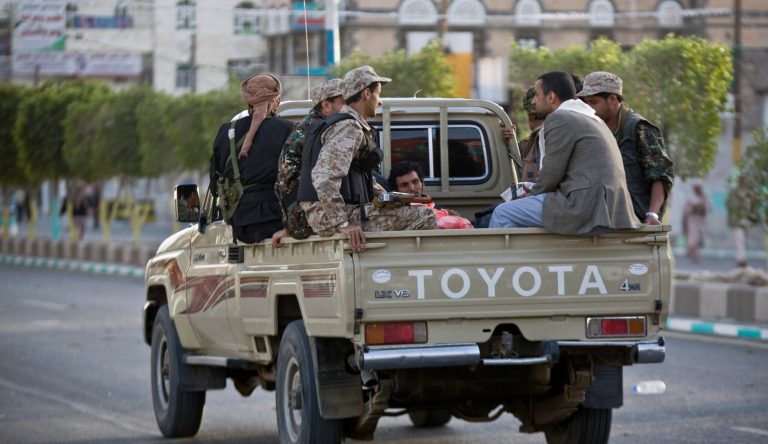 Houthi Shiite fighters wearing an army uniform ride on a pickup truck as they patrol a street during a demonstration to show support for their comrades in Sanaa, Yemen, Friday, Jan. 23, 2015. (AP Photo/Hani Mohammed)