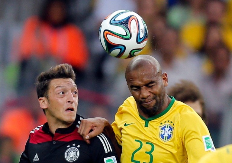 Germany's Mesut Ozil, left, and Brazil's Maicon go for a header during the World Cup semifinal soccer match between Brazil and Germany at the Mineirao Stadium in Belo Horizonte, Brazil, Tuesday, July 8, 2014. (AP Photo/Frank Augstein)