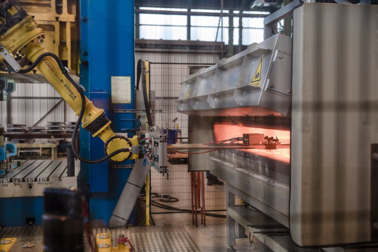 A robotic arm removes sheets for steel from a furnace at the ArcelorMittal research center in France. The European Union plans to seek an exemption from President Trump's tariffs on steel and aluminum imports. (Marlene Awaad/Bloomberg)