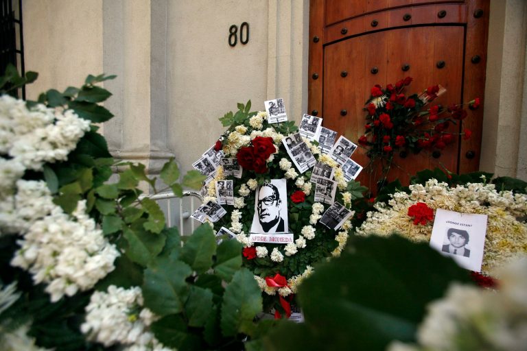 An offering of flowers marking the 41st anniversary of Chile's 1973 military coup, stands in front of the east side entrance of La Moneda presidential palace, referred to by it's street address, Morande 80, in Santiago, Chile, Thursday, Sept. 11, 2014. The coup toppled Chilean President Salvador Allende and began the military dictatorship of Gen. Augusto Pinochet. Allende used the side door to enter and leave the palace. It was also through this door his body was carried by soldiers and firefighters from the destroyed presidential palace after the coup. (AP Photo/Luis Hidalgo)