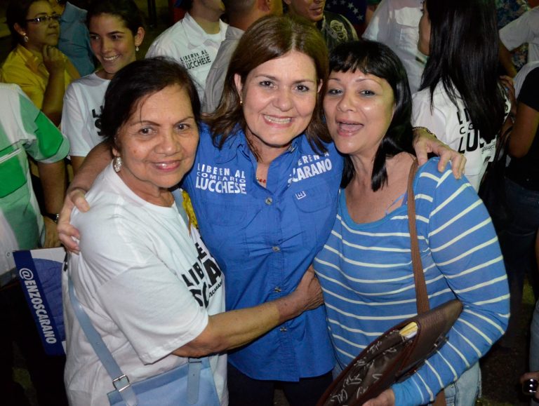 In this May 19, 2014 photo released by the Rosa Brandonisio Press Office, mayoral candidate Rosa Brandonisio, center, poses with supporters during a campaign rally in San Diego, Venezuela. Brandonisio, 54, had scant experience in politics when her husband was ousted in March, at the height of unrest, and arrested for allegedly failing to carry out a government order to remove street barricades in the opposition strongholds they governed. Although women occupy positions of power within Maduro's Cabinet, the armed forces and as pro-government community activists, their prominence within the opposition leadership is more recent, a result of a crackdown that has forced several to serve as stand-ins for their imprisoned husbands. (AP Photo/Rosa Brandonisio Press Office)