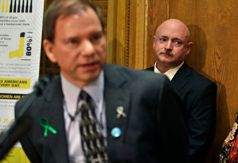 Mark Kelly, husband of former U.S. Rep. Gabrielle Giffords, listens to Tom Mauser, the father of Columbine High School shooting victim Daniel Mauser, speak during a news conference in favor of proposed gun control legislation at the State Capitol, in Denver, Monday March 4, 2013. State Senate committees began work Monday on a package of gun-control measures that already have cleared the House which include limits on ammunition magazine sizes and expanded background checks to include private sales and online purchases. (AP Photo/Brennan Linsley)