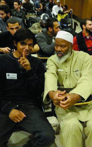 This handout photo provided by Jamill Noorata, taken May 3, 2012, shows Shamiur Rahman, left, sitting with Siraj Wahhaj at John Jay Community College in New York. Rahman, a 19-year-old American of Bengali descent who has now denounced his work, was a paid informant for the New York Police Department's intelligence unit was under orders to 