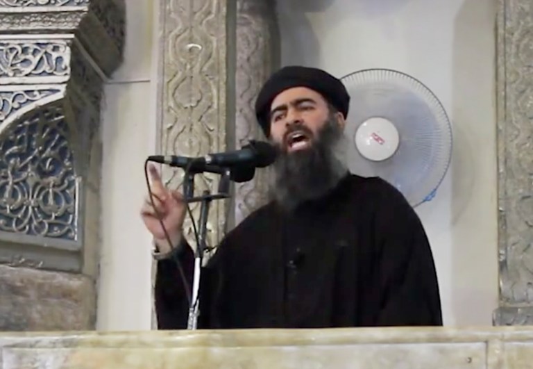 This image made from video posted on a militant website Saturday, July 5, 2014, which has been authenticated based on its contents and other AP reporting, purports to show the leader of the Islamic State group, Abu Bakr al-Baghdadi, delivering a sermon at a mosque in Iraq. A video posted online Saturday purports to show the leader of the Islamic State extremist group that has overrun much of Syria and Iraq delivering a sermon at a mosque in Iraq, in what would be a rare - if not the first - public appearance by the shadowy militant. (AP Photo/Militant video)