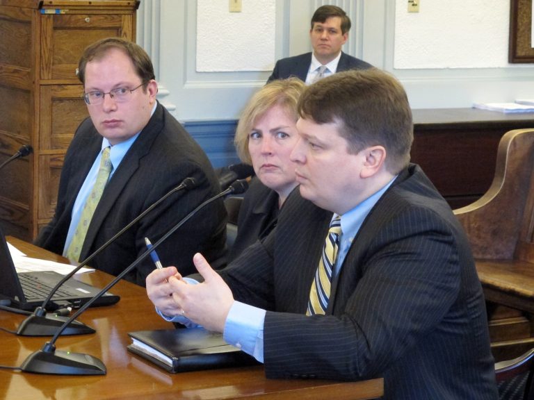 State Natural Resources Commissioner Joe Balash, foreground, addresses the Senate Finance Committee during an overview of plans to advance a liquefied natural gas project on Monday, Jan. 27, 2014, in Juneau, Alaska. Pictured alongside Balash are, from left, Mike Pawlowski, a deputy Revenue commissioner, and Revenue Commissioner Angela Rodell, center. Shown in the background is Sen. Bill Wielechowski, D-Anchorage, one of several legislators who sat in on the presentation. (AP Photo/Becky Bohrer)