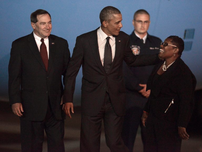 President Barack Obama center, jokes with Gary (Ind.) Mayor Karen Freeman-Wilson right, while Sen. Joe Donnely, D-Ind., left, watches after Obama arrived at the Gary/Chicago International Airport in Gary, Ind., Wednesday, Oct. 1, 2014. (AP Photo/Paul Beaty)
