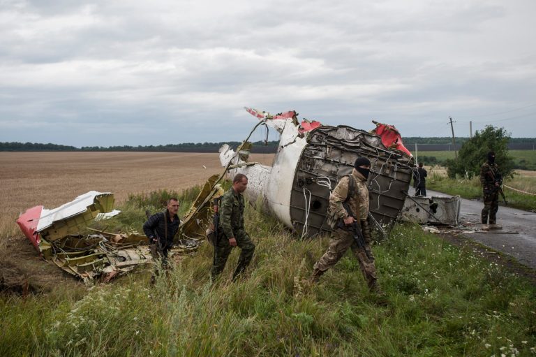 Pro-Russian fighters at the crash site of a Malaysia Airlines passenger jet near the village of Hrabove, Ukraine. (AP Photo/Evgeniy Maloletka)