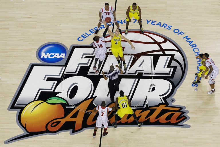 Louisville and Michigan tip off in the NCAA national championship game in Atlanta in April. (AP/David J. Phillip)