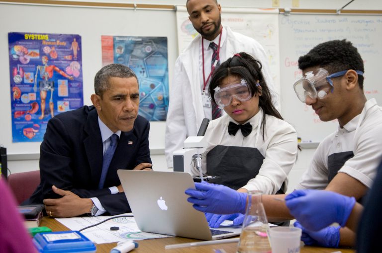 President Barack Obama listens to students as he visits a classroom at Bladensburg High School in Bladensburg, Md., Monday before speaking about the economy and to announce the winners of a competition he launched last fall to bring together educators and employers to redesign the high school experience to give students access to real-world career skills and college-level courses. (AP Photo/Carolyn Kaster)