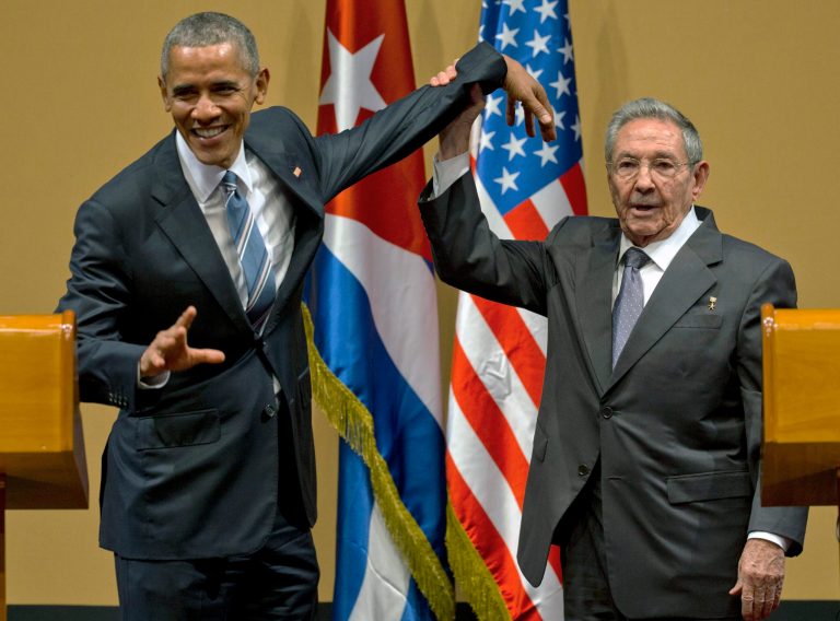 Cuban President Raul Castro, right, tries to lift up the arm of President Barack Obama at the conclusion of their joint news conference at the Palace of the Revolution, Monday, March 21, 2016, in Havana, Cuba.