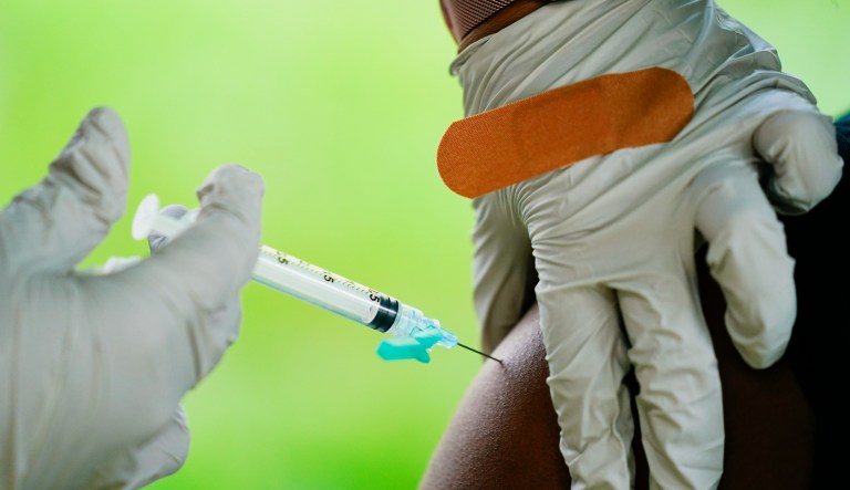 A health worker administers a dose of a Pfizer COVID-19 vaccine during a vaccination clinic at the Reading Area Community College in Reading, Pa., Tuesday, Sept. 14, 2021. 