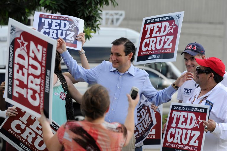 Former Texas Solicitor General Ted Cruz, center, greets supporters at a voting precinct Tuesday, July 31, 2012, in Houston. Cruz faces Lt. Gov. David Dewhurst in the Republican primary runoff election for the Republican nomination for the U.S. Senate. (AP Photo/Pat Sullivan)