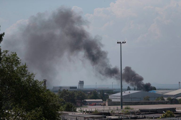 Smoke rises at the airport outside Donetsk, Ukraine, Monday, May 26, 2014. Ukraine's military launched airstrikes Monday against the separatists who had taken over the airport in the eastern city of Donetsk, suggesting that fighting in the east is far from over. (AP Photo/Ivan Sekretarev)