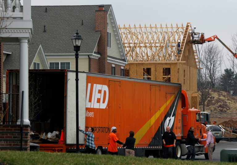 In this April 17, 2011 photo, construction continues on a new home in Newtown, Pa., as a moving van finishes unloading at a newly completed home. (AP Photo/Mel Evans)