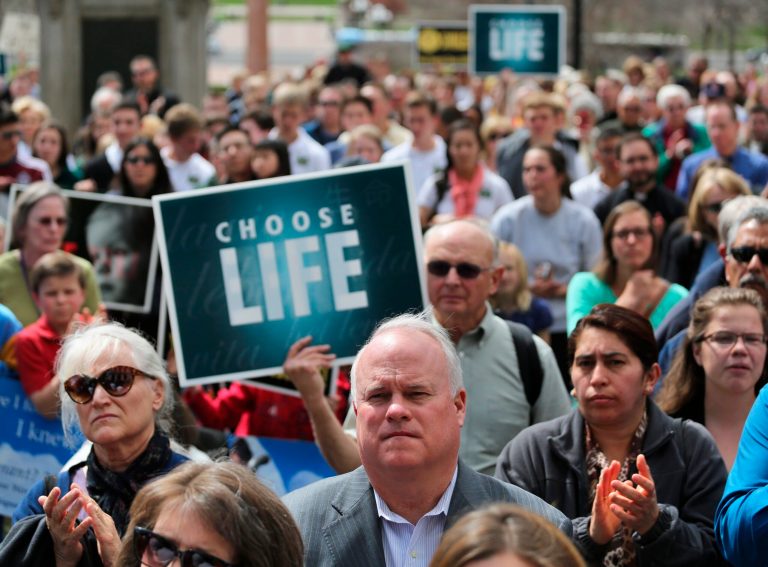 Demonstrators rally against Colorado Senate Bill 175, in a protest attended by Archbishop of Denver Samuel J. Aquila, on the steps of the state capitol in Denver. (AP/Brennan Linsley)