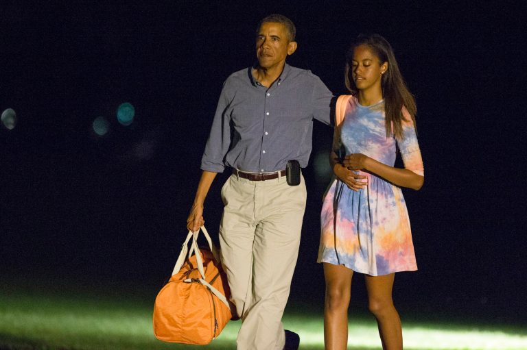 President Obama walks with his daughter Malia as he arrives on the South Lawn of the White House on Monday. Obama is taking a break in the middle of his Martha's Vineyard vacation to return to Washington for meetings with Vice President Joe Biden and other advisers on the U.S. military campaign in Iraq and tensions between police and protesters in Ferguson, Mo. (AP Photo/Evan Vucci)