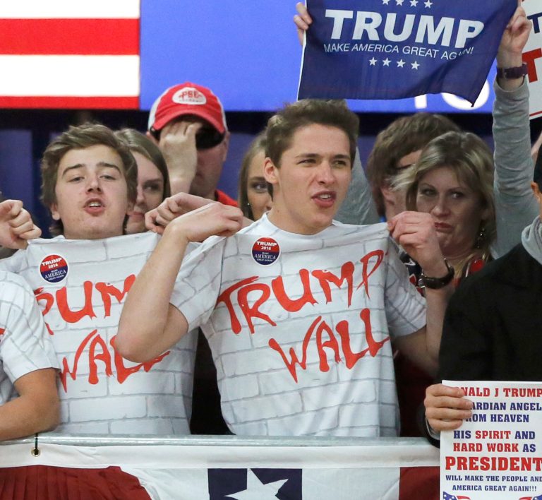 Supporters of Republican presidential candidate, Donald Trump, chant, Build That Wall, before a town hall Saturday, April 2, 2016, in Rothschild, Wis. (AP Photo/Charles Rex Arbogast)
