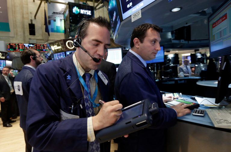 Trader Gregory Rowe, left, works on the floor of the New York Stock Exchange Tuesday, May 27, 2014. Stocks rose Tuesday after the government reported that orders for big-ticket items rose unexpectedly last month. (AP Photo/Richard Drew)