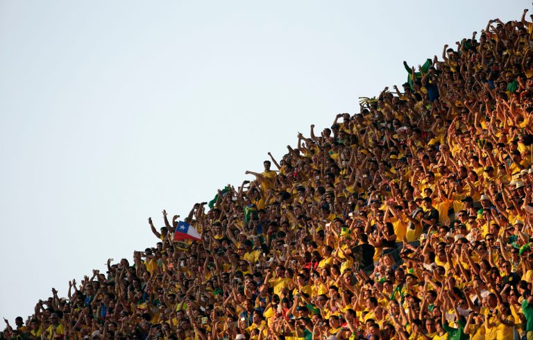 Fans cheer before the group A World Cup soccer match between Brazil and Croatia, the opening game of the tournament, in the Itaquerao Stadium in Sao Paulo, Brazil, Thursday, June 12, 2014.  (AP Photo/Felipe Dana)