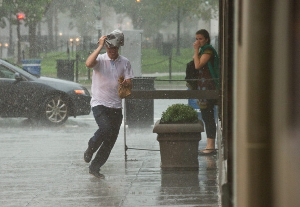 A man runs for cover during a heavy rainstorm in Washington on Saturday. (Getty Images)