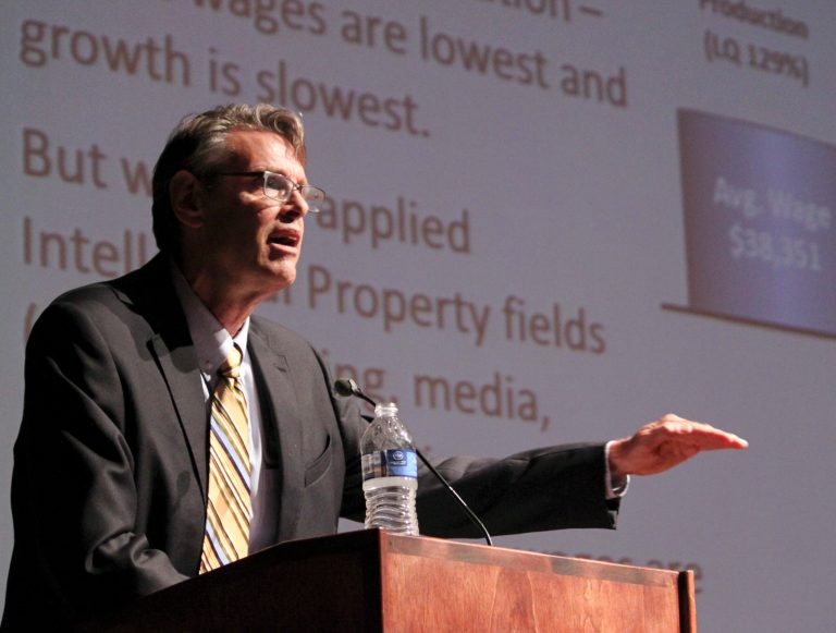 Jeff Mitchell, the director of the Bureau of Business and Economic Research at the University of New Mexico, details the findings of a comprehensive study of the economic impacts of New Mexico's arts and culture industries during a news conference in Albuquerque, N.M. on Wednesday, Aug. 13, 2014. The report found that the industries employ more than 76,000 people and have an economic impact of about $5.6 billion. (AP Photo/Susan Montoya Bryan)
