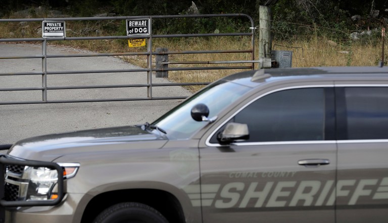 A law enforcement vehicle sits outside the entrance where Devin Patrick Kelley lived Monday, Nov. 6, 2017, in New Braunfels, Texas. Texas officials confirmed Kelley as the shooter who killed more than 20 people and wounded others at a church in Sutherland Spring, Texas, Sunday. (AP Photo/David J. Phillip)