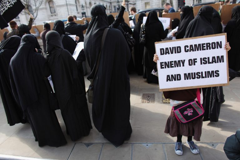 Muslim men and women protest opposite Downing Street on March 21, 2011 in London. (Photo by Oli Scarff/Getty images)
