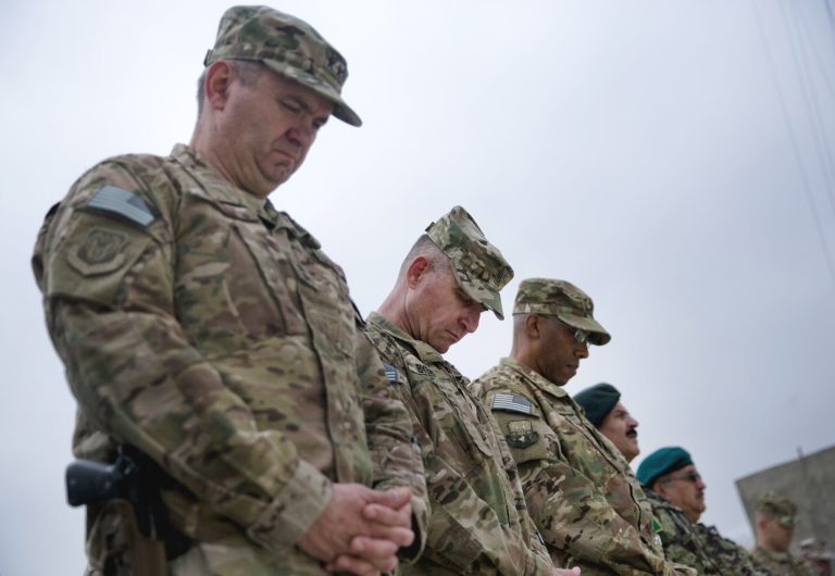 U.S. military officers pay respect during a change of command ceremony in FOB Oqab, Kabul, Afghanistan, Monday, July 27, 2015. (AP Photo/Massoud Hossaini)