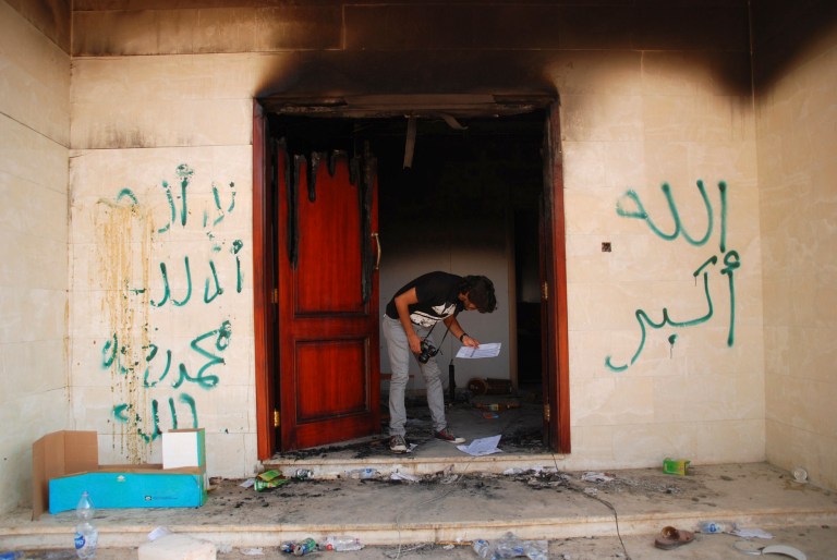 A man looks at documents at the U.S. consulate in Benghazi, Libya, after an attack that killed four Americans, including Ambassador Chris Stevens. (AP/Ibrahim Alaguri)
