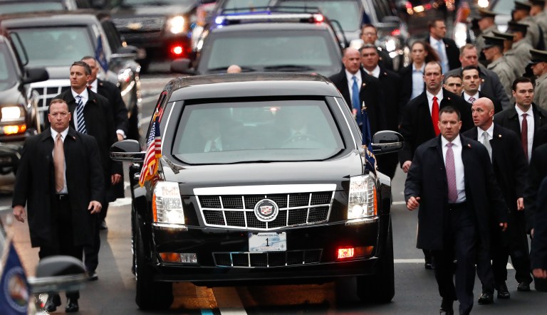 Members of President Donald Trump's Secret Service detail walk with the First Family's motorcade vehicle as they move alone the Inauguration Day Parade Route in Washington, Friday, Jan. 20, 2017, after Donald Trump was sworn in as the 45th president of the United States. (AP Photo/Carolyn Kaster)