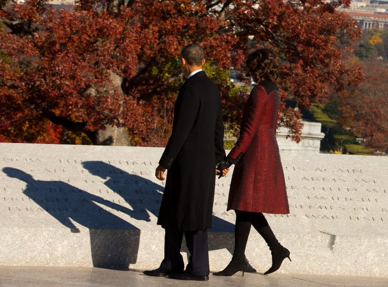 President Barack Obama and first lady Michelle Obama read the inscriptions after a wreath laying ceremony in honor of President John F. Kennedy on Nov. 20 at the Kennedy gravesite at Arlington National Cemetery.  (AP Photo/Pablo Martinez Monsivais)