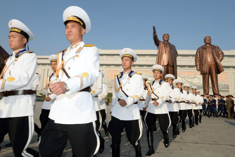 North Korean military personnel march as they visit the statues of late leaders, Kim Il Sung, left, and Kim Jong Il on Mansudae to mark the 69th anniversary of the founding of the ruling Workers' Party of Korea, in Pyongyang, North Korea Friday, Oct. 10, 2014. (AP Photo/Kyodo News) JAPAN OUT, MANDATORY CREDIT
