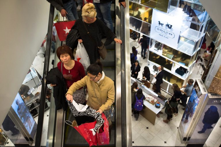FILE - In this Nov. 28, 2013, file photo, shoppers descend on an escalator at the Macy's Herald Square store in New York. Macy's Inc. reports quarterly financial results before the market opens on Tuesday, Feb. 25, 2014. (AP Photo/John Minchillo, File)