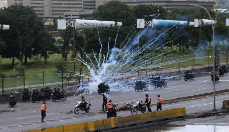 Fireworks launched by anti-government protesters explode near government forces in Venezuela. Protesters have flooded the streets of Venezuela for months, demanding new elections and faulting President Nicolas Maduro's leadership. (AP Photo/Fernando Llano)