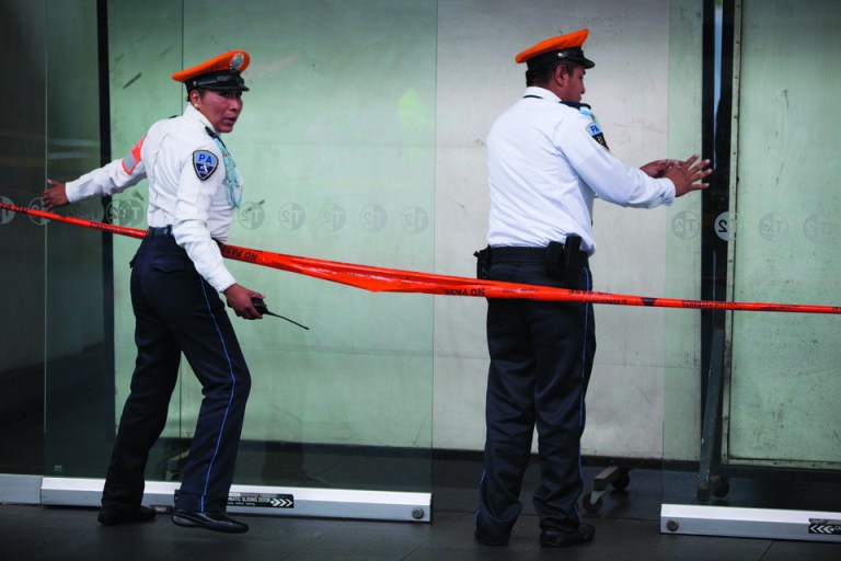 Airport police officers block the entrance where a shooting took place in Mexico City's international airport on Monday, June 25, 2012. Two people were shot to death and one was wounded at one of the airport's terminal and according to the federal Public Safety Department, at least one was a Federal Police officer. Details of the shooting are still unclear. (AP Photo/Alexandre Meneghini)