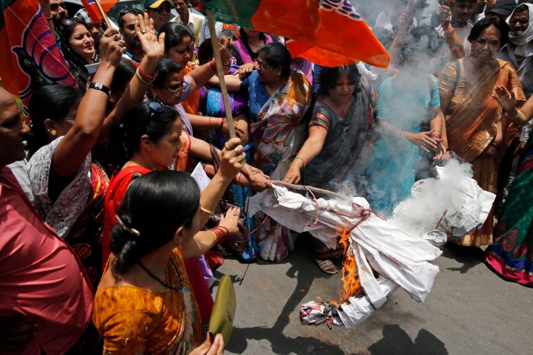 Bharatiya Janata Party (BJP) women workers raise slogans and burn an effigy of Akhilesh Yadav, chief minister of the northern Indian state of Uttar Pradesh, during a protest against the gang rape of two teenage girls, in Allahabad, India, Saturday, May 31, 2014. Police arrested a third suspect and hunted for two others Saturday in the gang rape and slaying of two teenage cousins found hanging from a tree in Katra village, in Uttar Pradesh, a case that has prompted national outrage. (AP Photo/ Rajesh Kumar Singh)