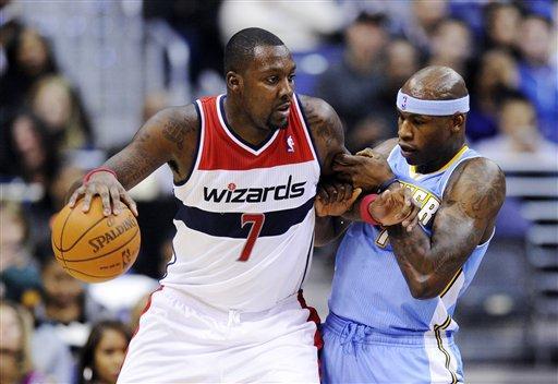 Washington Wizards forward Andray Blatche (7) drives to the basket against Denver Nuggets forward Al Harrington, right, during the first half of an NBA basketball game, Friday, Jan. 20, 2012, in Washington. The Nuggets won 108-104. (AP Photo/Nick Wass)