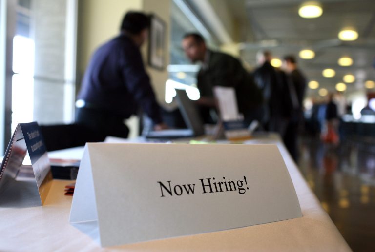 A 'now hiring' sign is posted on a table during the Recruit Military Career Fair March 19, 2009 at AT&T Park in San Francisco, California. (Photo by Justin Sullivan/Getty Images)