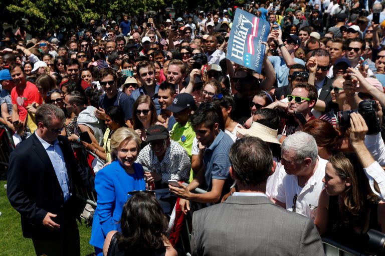 Democratic presidential candidate, former Secretary of State Hillary Rodham Clinton, center left, poses for a photograph with a supporter Saturday, June 13, 2015, on Roosevelt Island in New York. (AP Photo/Julio Cortez)