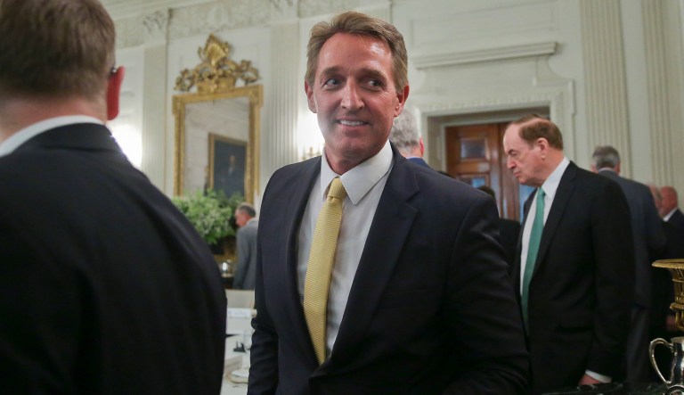 In this July 19, 2017, file photo, Sen. Jeff Flake, R-Ariz., center, walks to his seat as he attends a luncheon with other GOP Senators and President Trump in the State Dinning Room of the White House in Washington. Also in the room is Sen. Richard Shelby, R-Ala., right.