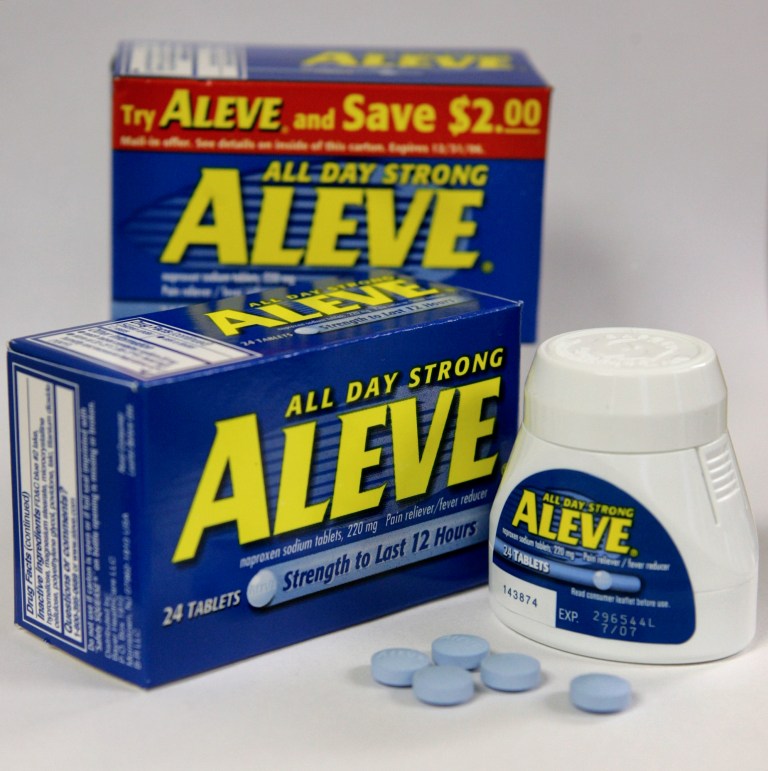 FILE - In this Tuesday, Dec. 21, 2004, file photo, several Aleve tablets appear in front of bottles of the pain reliever, in Boston.  Federal health experts are taking a second look this week at the heart safety of pain medications used by millions of Americans to treat arthritis and other everyday aches and pains. (AP Photo/Steven Senne, File)
