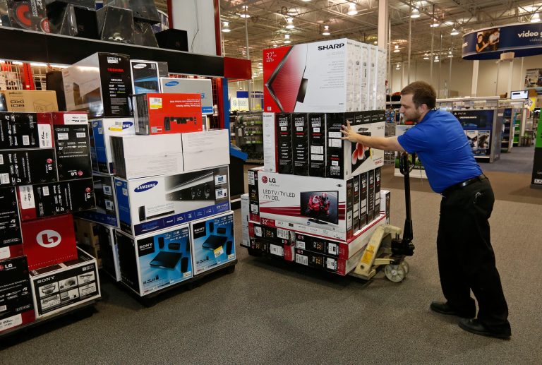 In this Tuesday, Nov. 26, 2013, photo, Chris Busch, multichannel sales support manager at an Oklahoma City Best Buy store, moves inventory at the store in Oklahoma City, Tuesday, Nov. 26, 2013. The government reports how much U.S. businesses adjusted their stockpiles in October on Thursday, Dec. 12, 2013. (AP Photo/Sue Ogrocki)