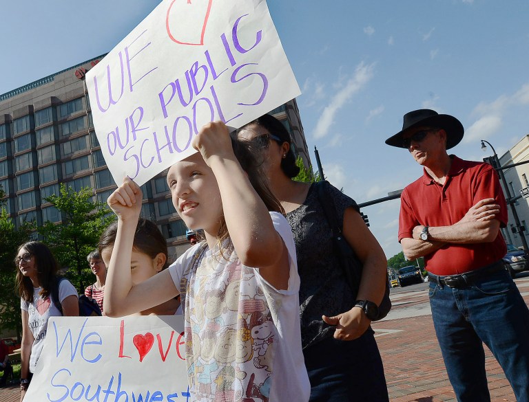 Employees who are members of the North Carolina Staff Organization say they haven't received salary increases in eight years. (Bernard Thomas/The Herald-Sun via AP)